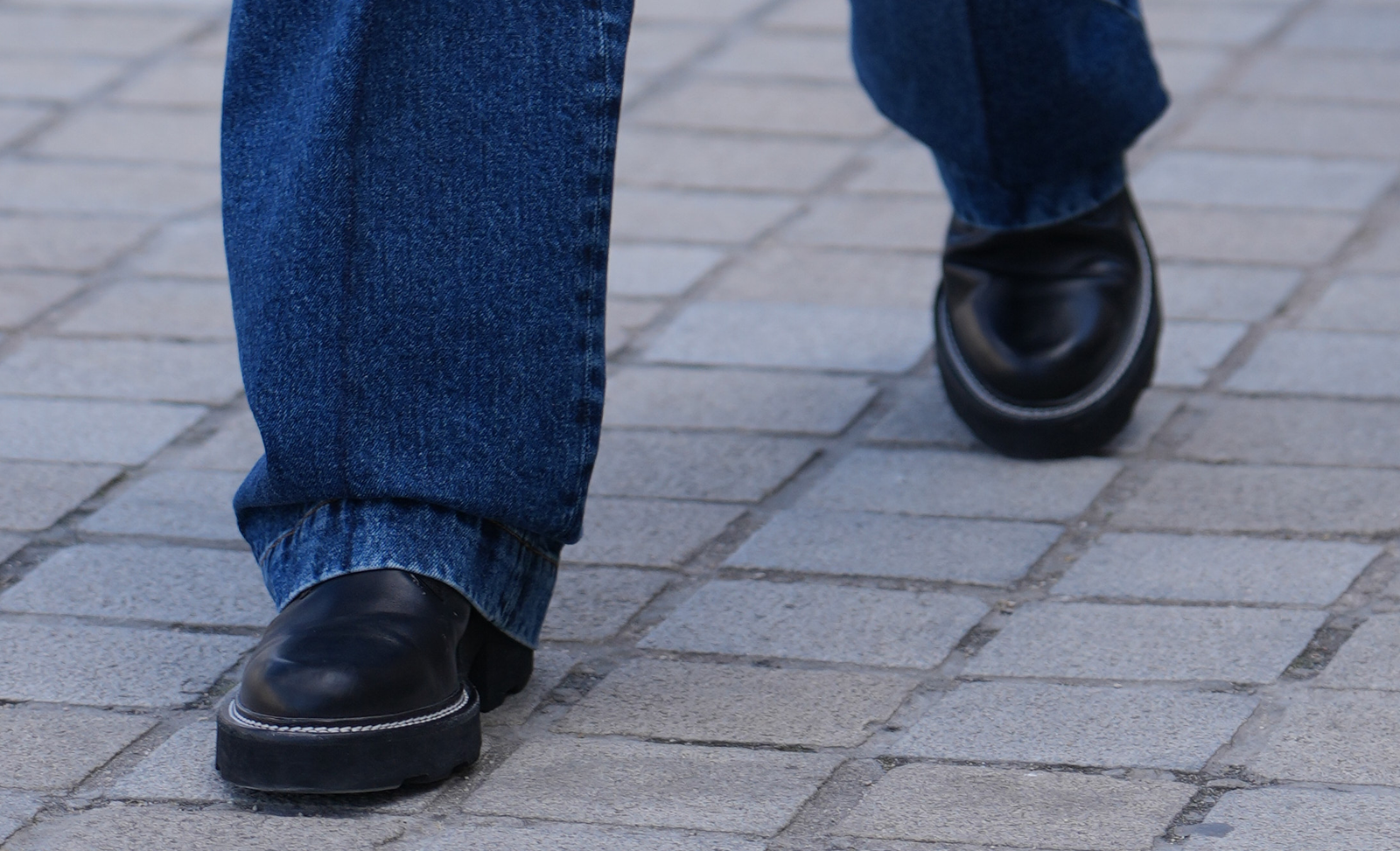 Close-up of Jaden Smith's block-heel, chain-trimmed leather shoes outside the Louis Vuitton spring 2026 show in Paris.